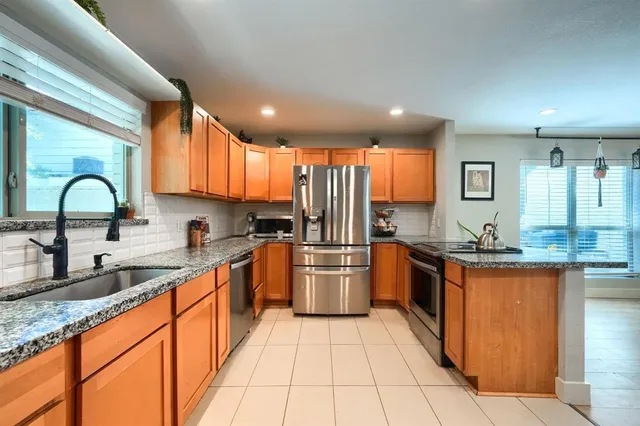 a kitchen with stainless steel appliances granite countertop a sink and cabinets