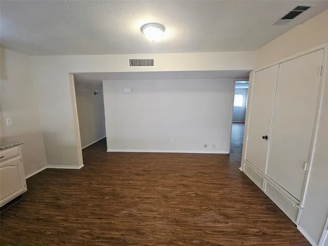 a view of hallway with wooden floor