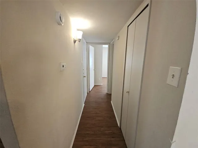 a view of a hallway with a wooden floor