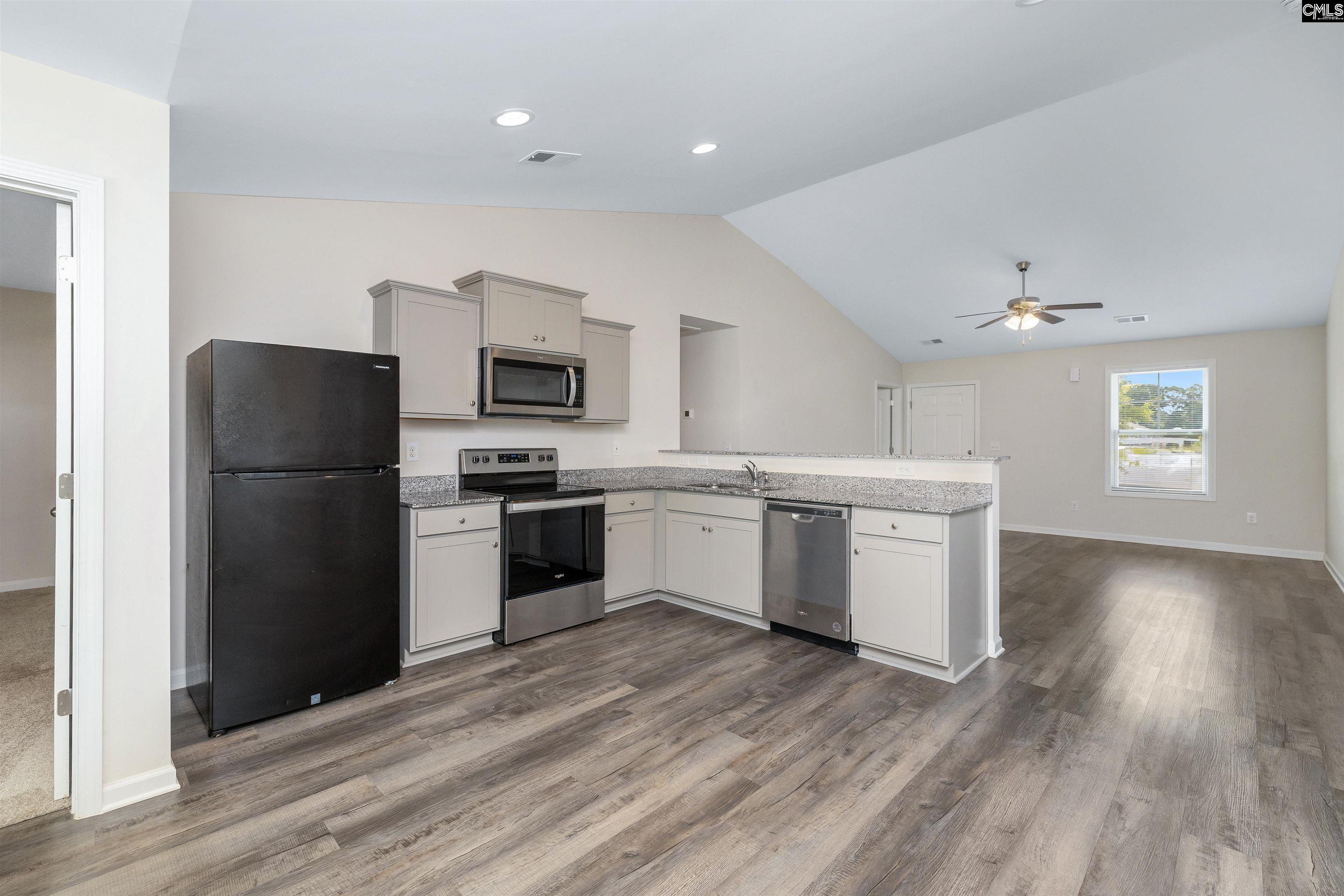 2157 Still Pointe Drive Sumter, SC 29154 - Photo 12 of 25 a kitchen with a refrigerator and a stove top oven