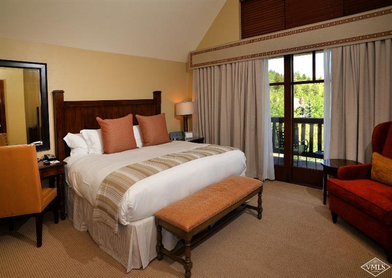 100 Bachelor Ridge Road, Unit 3704 Avon, CO 81620 - Photo 12 of 21 a spacious bedroom with a bed and a couch next to a window