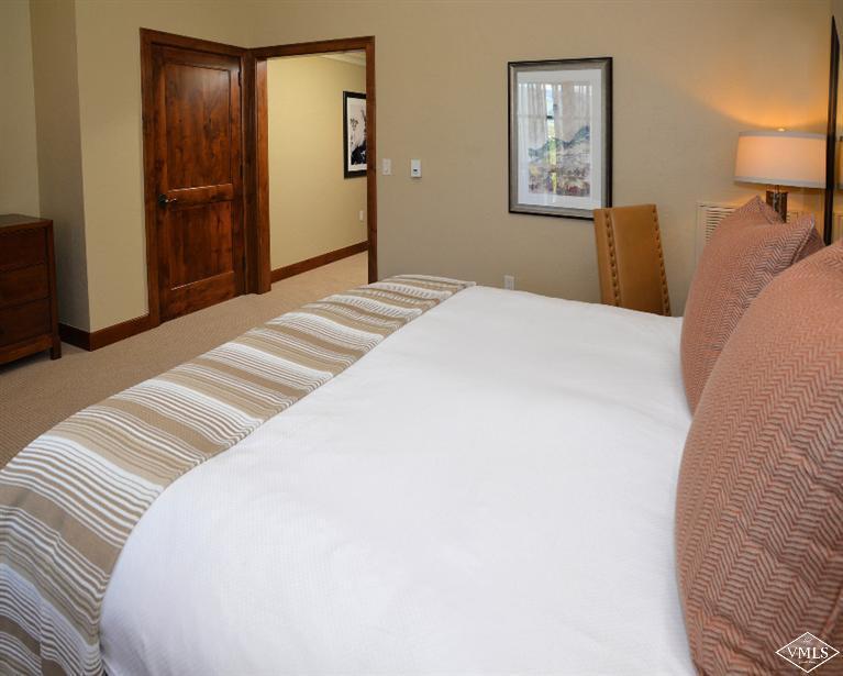 100 Bachelor Ridge Road, Unit 3704 Avon, CO 81620 - Photo 13 of 21 a bedroom with a bed and a lamp