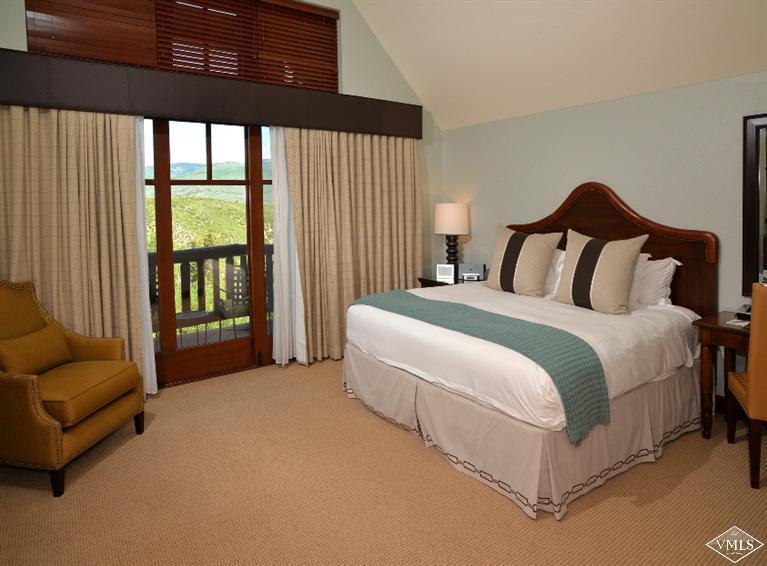 100 Bachelor Ridge Road, Unit 3704 Avon, CO 81620 - Photo 7 of 21 a spacious bedroom with a bed and a couch next to a window
