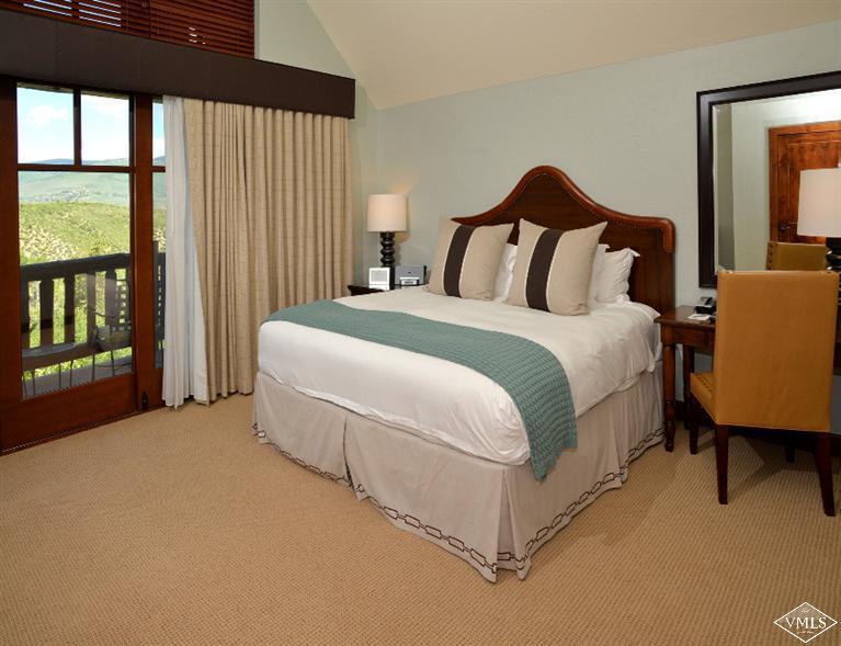 100 Bachelor Ridge Road, Unit 3704 Avon, CO 81620 - Photo 9 of 21 a large bed sitting in a bedroom next to a window