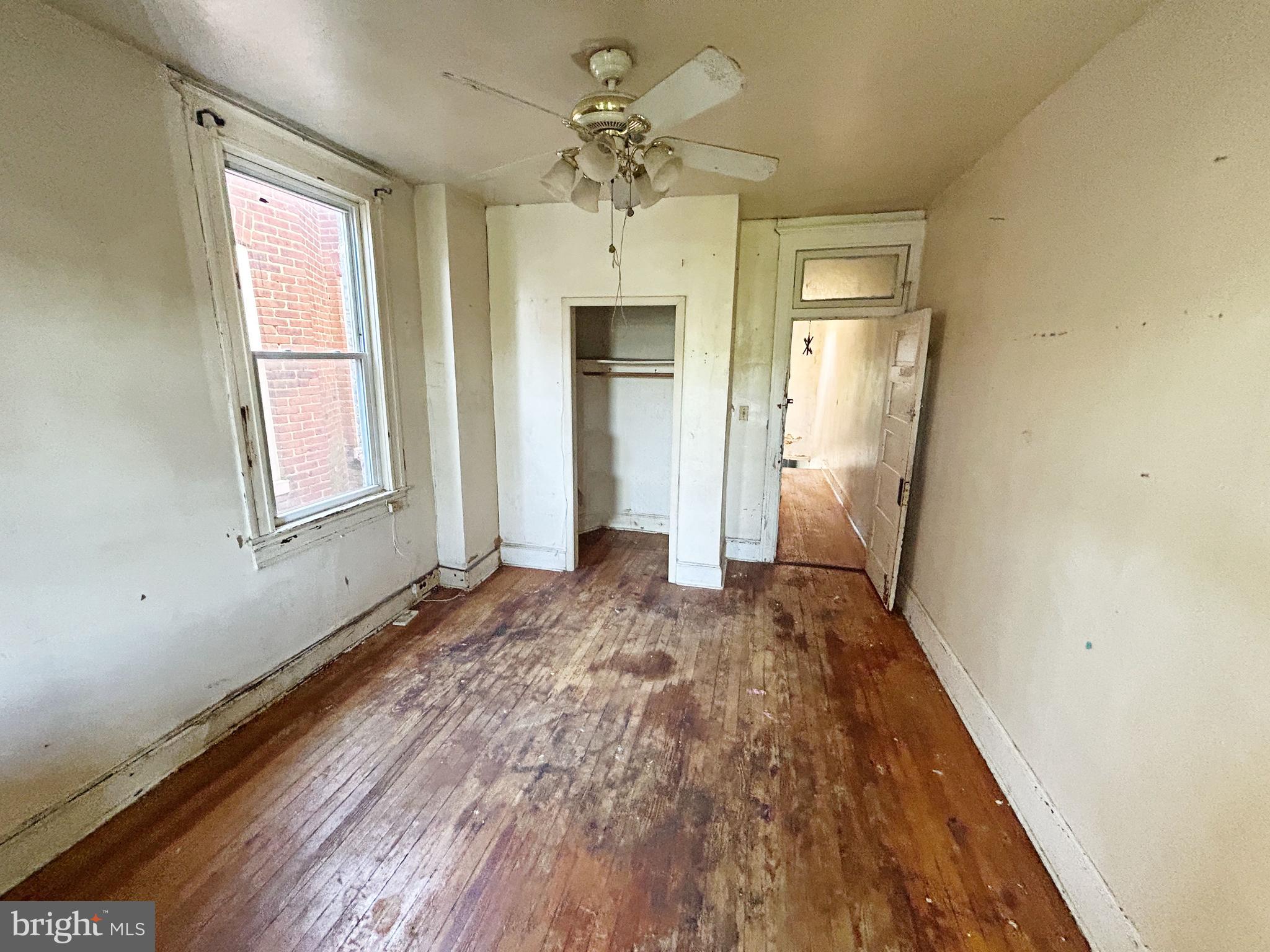 2904 Winchester Street Baltimore, MD 21216 - Photo 13 of 17 wooden floor in an empty room with a window