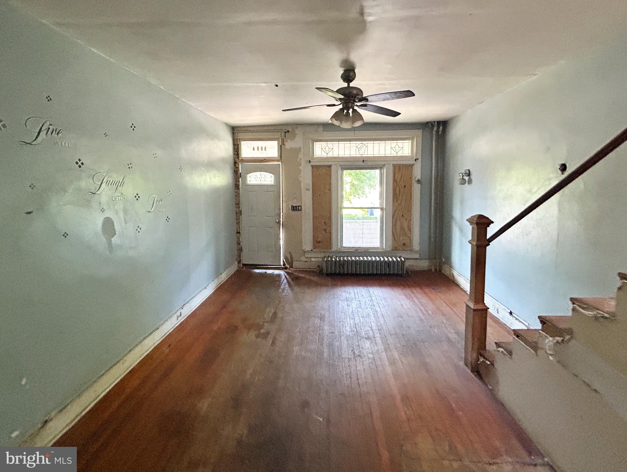 2904 Winchester Street Baltimore, MD 21216 - Photo 4 of 17 wooden floor in an empty room with a window