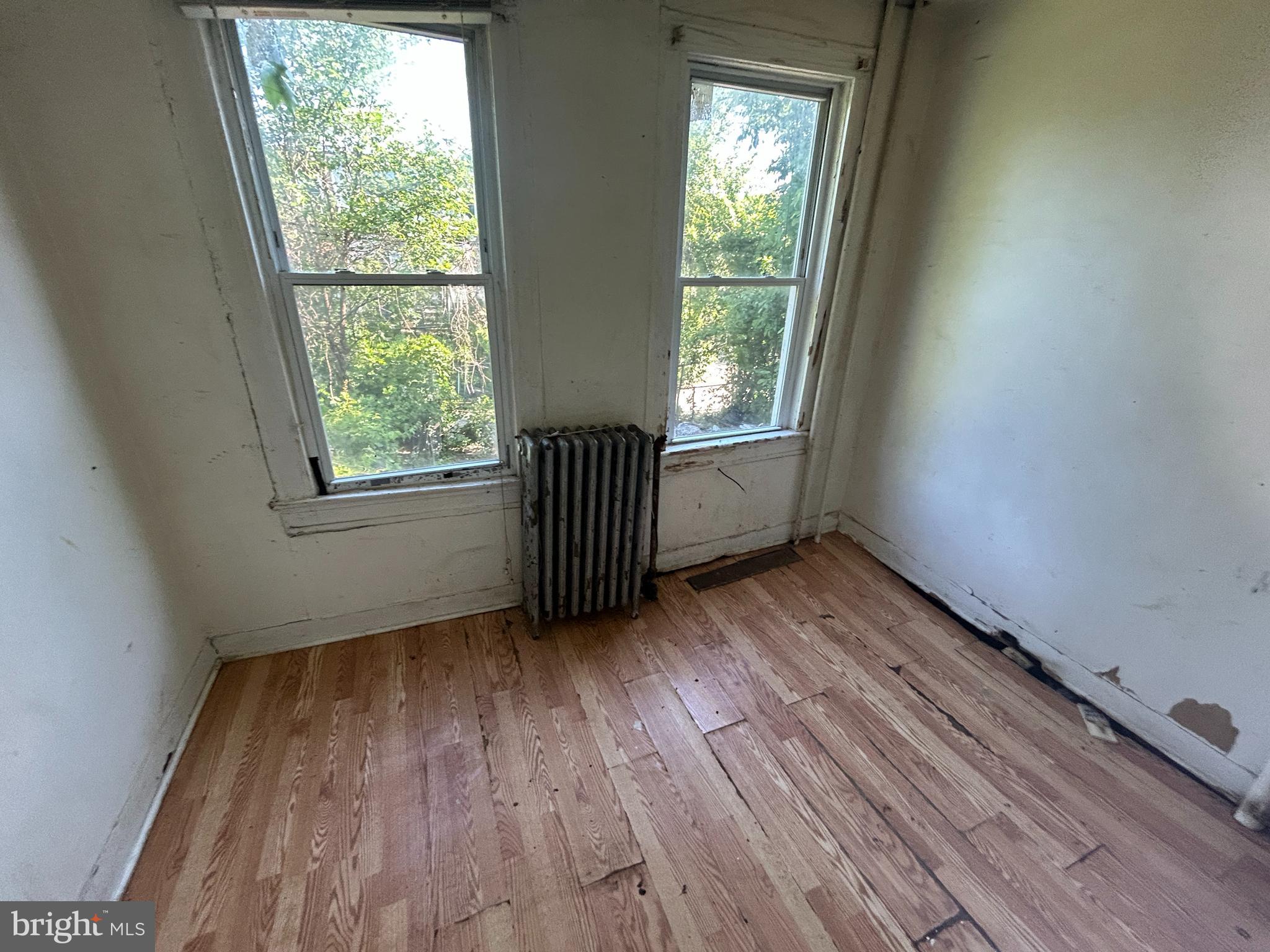 2904 Winchester Street Baltimore, MD 21216 - Photo 8 of 17 an empty room with wooden floor and windows