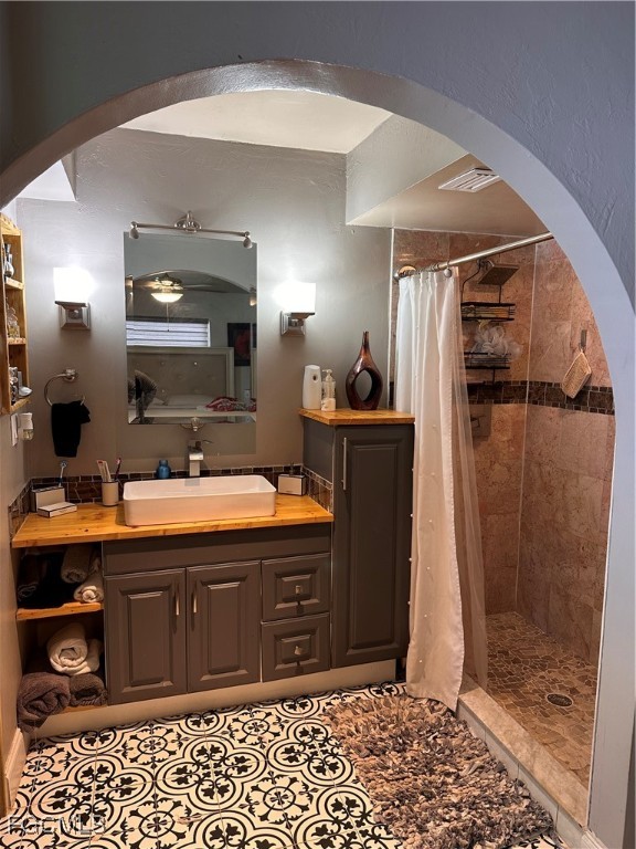 120 Rowland Road Lehigh Acres, FL 33936 - Photo 11 of 21 a spacious bathroom with a sink a mirror and a shower