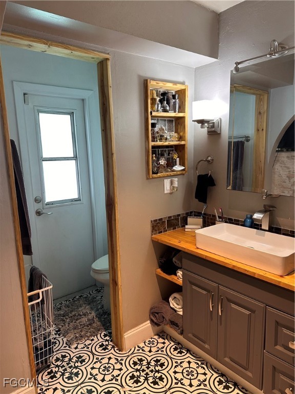 120 Rowland Road Lehigh Acres, FL 33936 - Photo 12 of 21 a bathroom with a sink a toilet and mirror