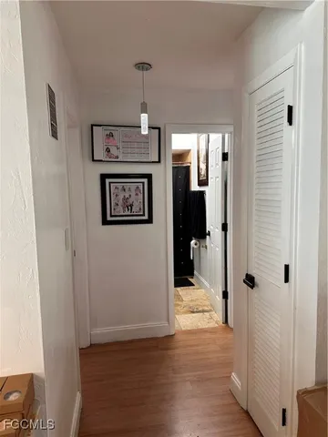 a view of a hallway with wooden floor and staircase