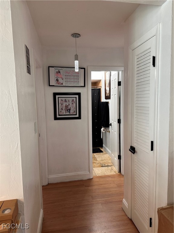 120 Rowland Road Lehigh Acres, FL 33936 - Photo 13 of 21 a view of a hallway with wooden floor and staircase