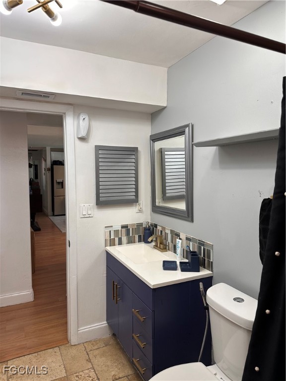120 Rowland Road Lehigh Acres, FL 33936 - Photo 14 of 21 a bathroom with a sink vanity mirror and toilet