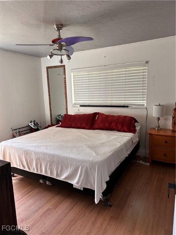 120 Rowland Road Lehigh Acres, FL 33936 - Photo 16 of 21 a bedroom with a bed and a chandelier