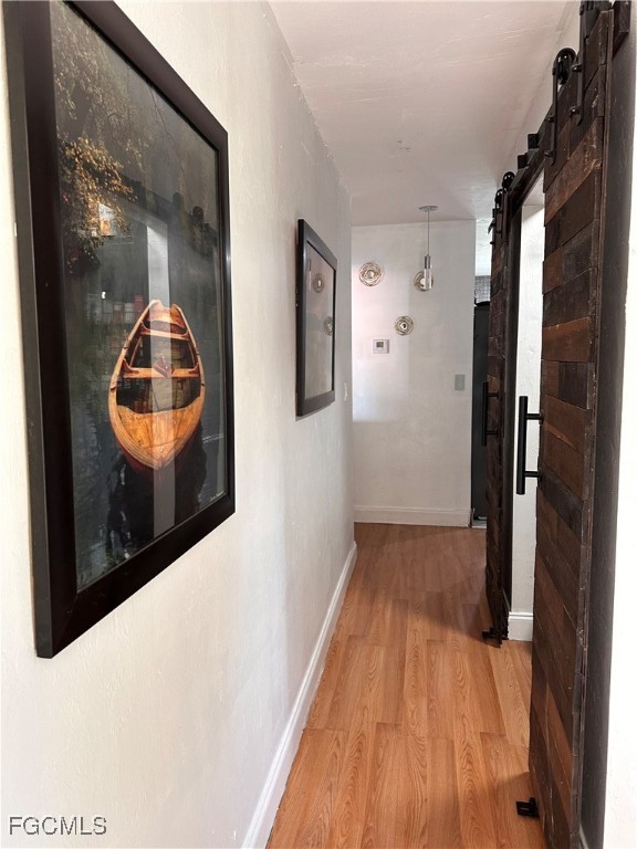 120 Rowland Road Lehigh Acres, FL 33936 - Photo 7 of 21 a view of a hallway with wooden floor and glass door