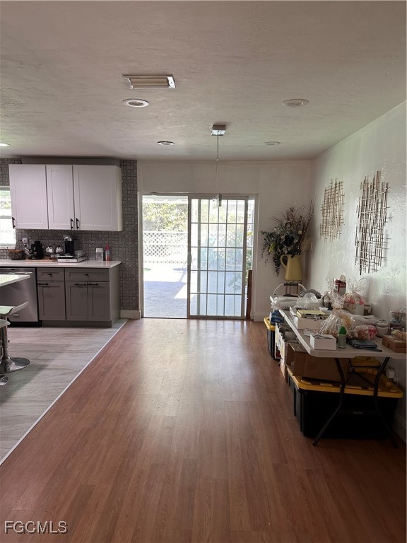 120 Rowland Road Lehigh Acres, FL 33936 - Photo 8 of 21 a living room with stainless steel appliances granite countertop a stove and a wooden floors