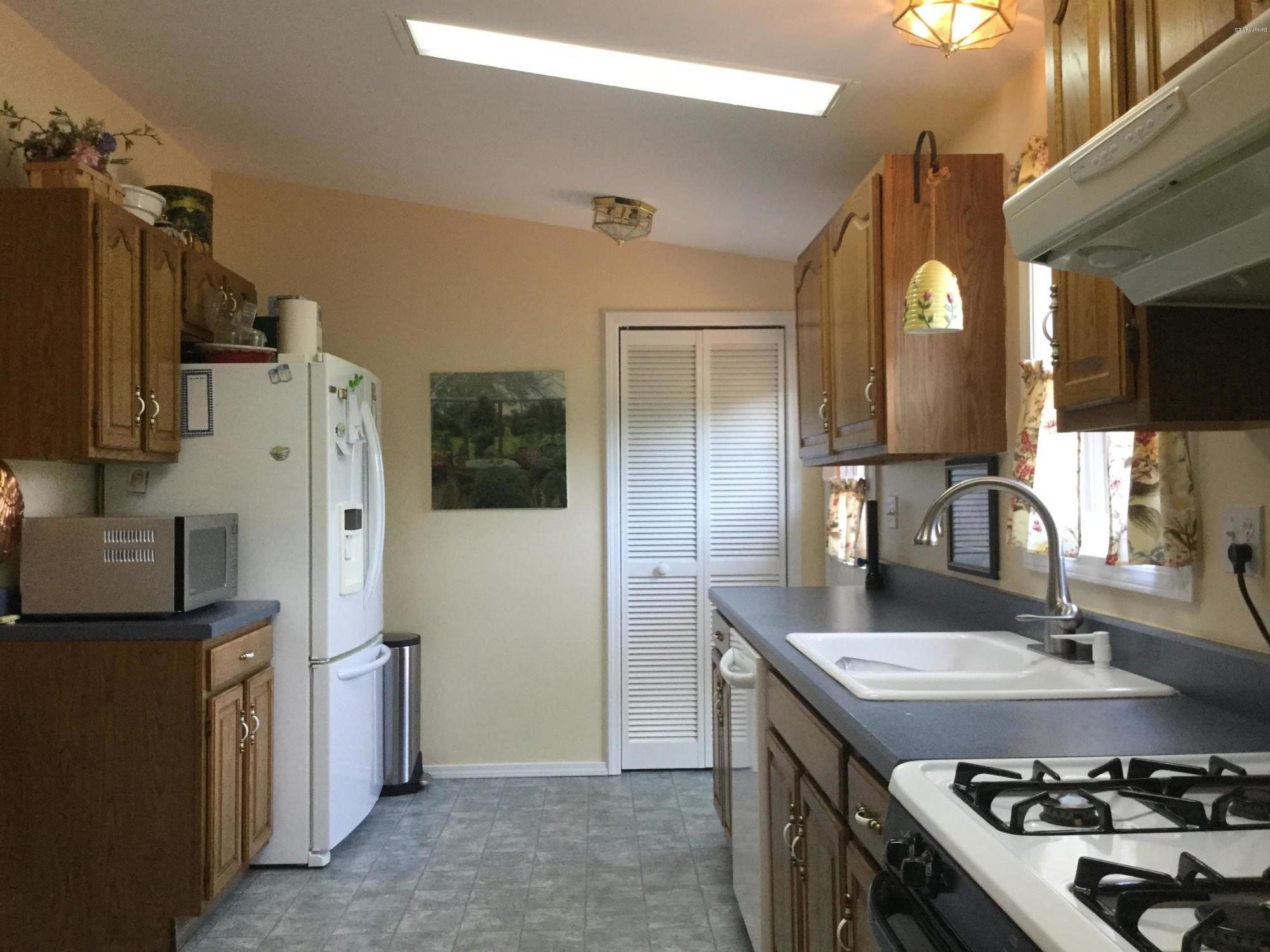 355 Salisbury Road Sheffield, MA 01257 - Photo 11 of 33 a kitchen with a sink stove and refrigerator