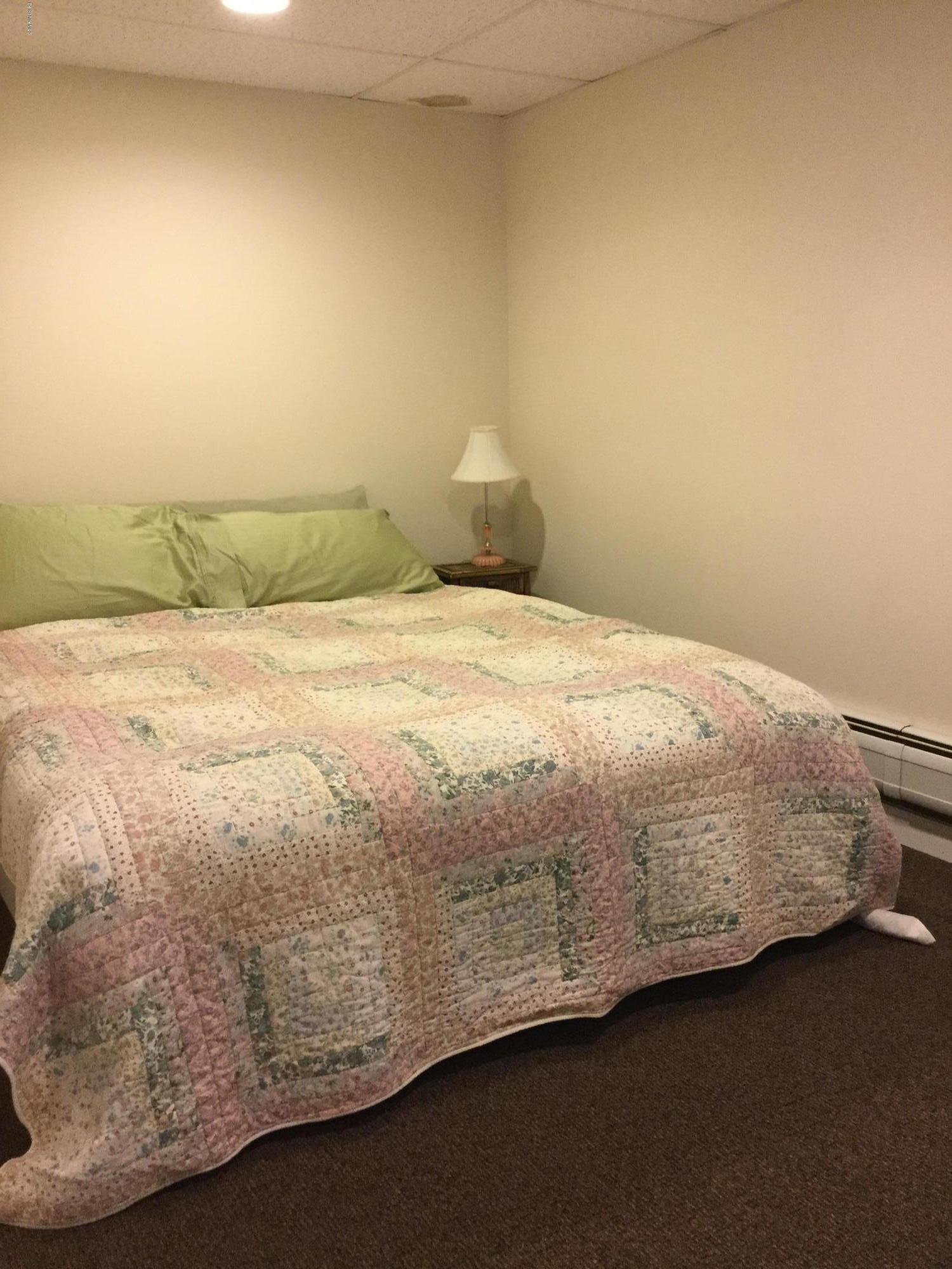 355 Salisbury Road Sheffield, MA 01257 - Photo 22 of 33 a bedroom with a bed and a cabinets
