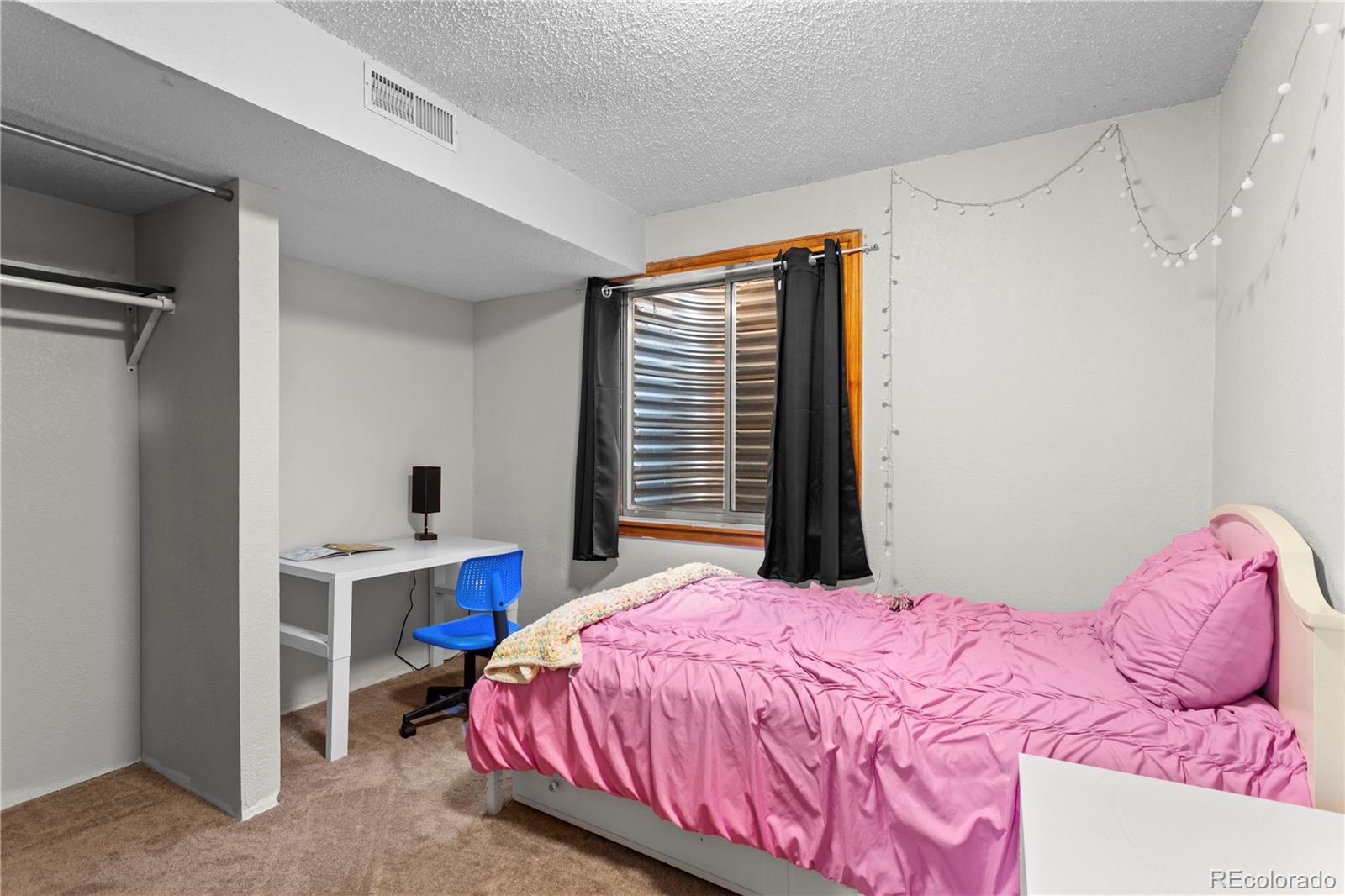2212 Hyacinth Road Littleton, CO 80129 - Photo 39 of 44 a bedroom with a bed and a desk