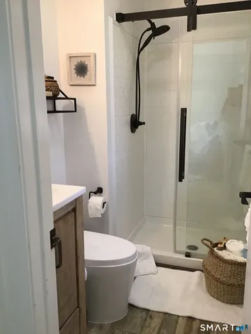 a bathroom with a sink toilet and shower
