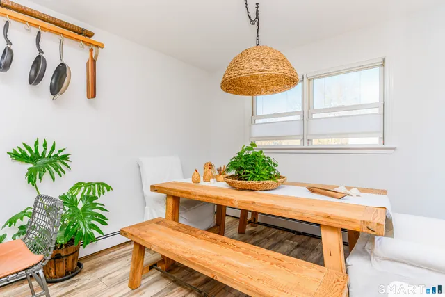 a view of a dining room with furniture and wooden floor