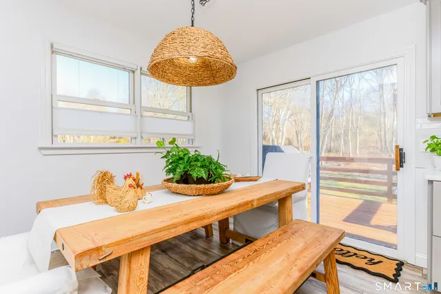 a view of a dining room with furniture and a window