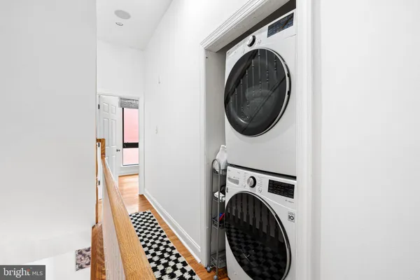 a view of a hallway with washer and dryer