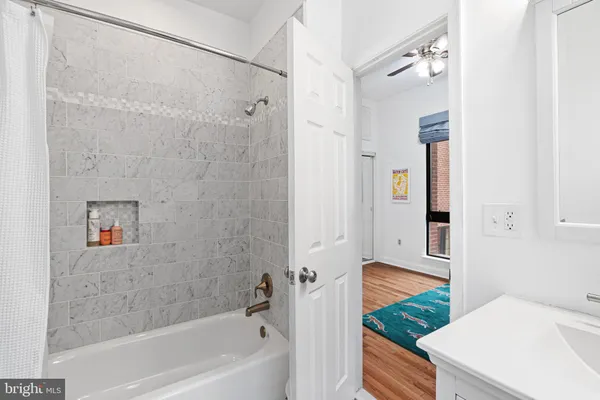 a bathroom with a bathtub and shower