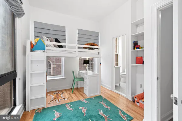a living room with furniture and a baby crib