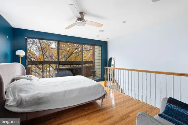 a bedroom with a bed and a large window