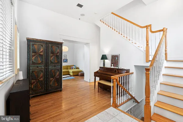 a view of a livingroom with wooden floor and furniture