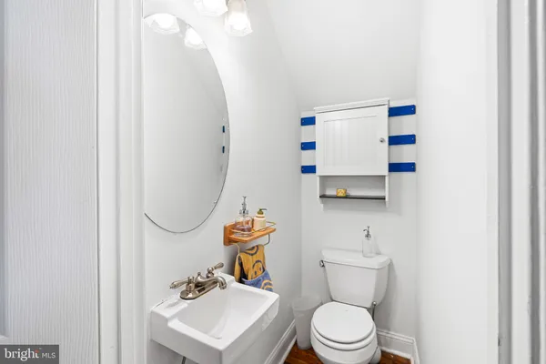 a white toilet sitting next to a bathroom sink
