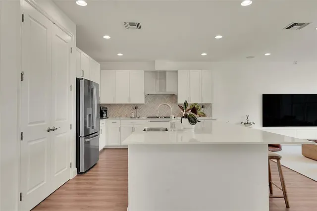 a kitchen with stainless steel appliances a refrigerator sink and microwave