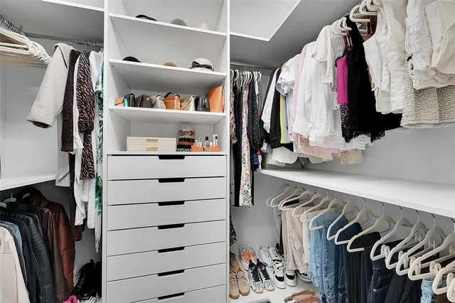 a bedroom with two beds and a night stand