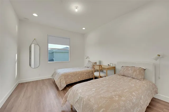 a bedroom with two beds and painted walls