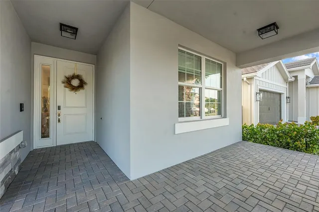 a view of an empty room with window and stairs