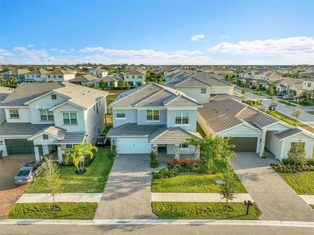an aerial view of residential houses with yard