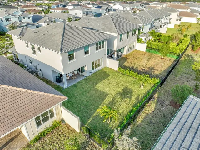 an aerial view of residential houses with yard