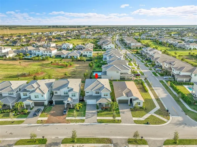 an aerial view of residential houses with outdoor space