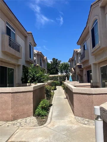a view of a patio with couches and potted plants
