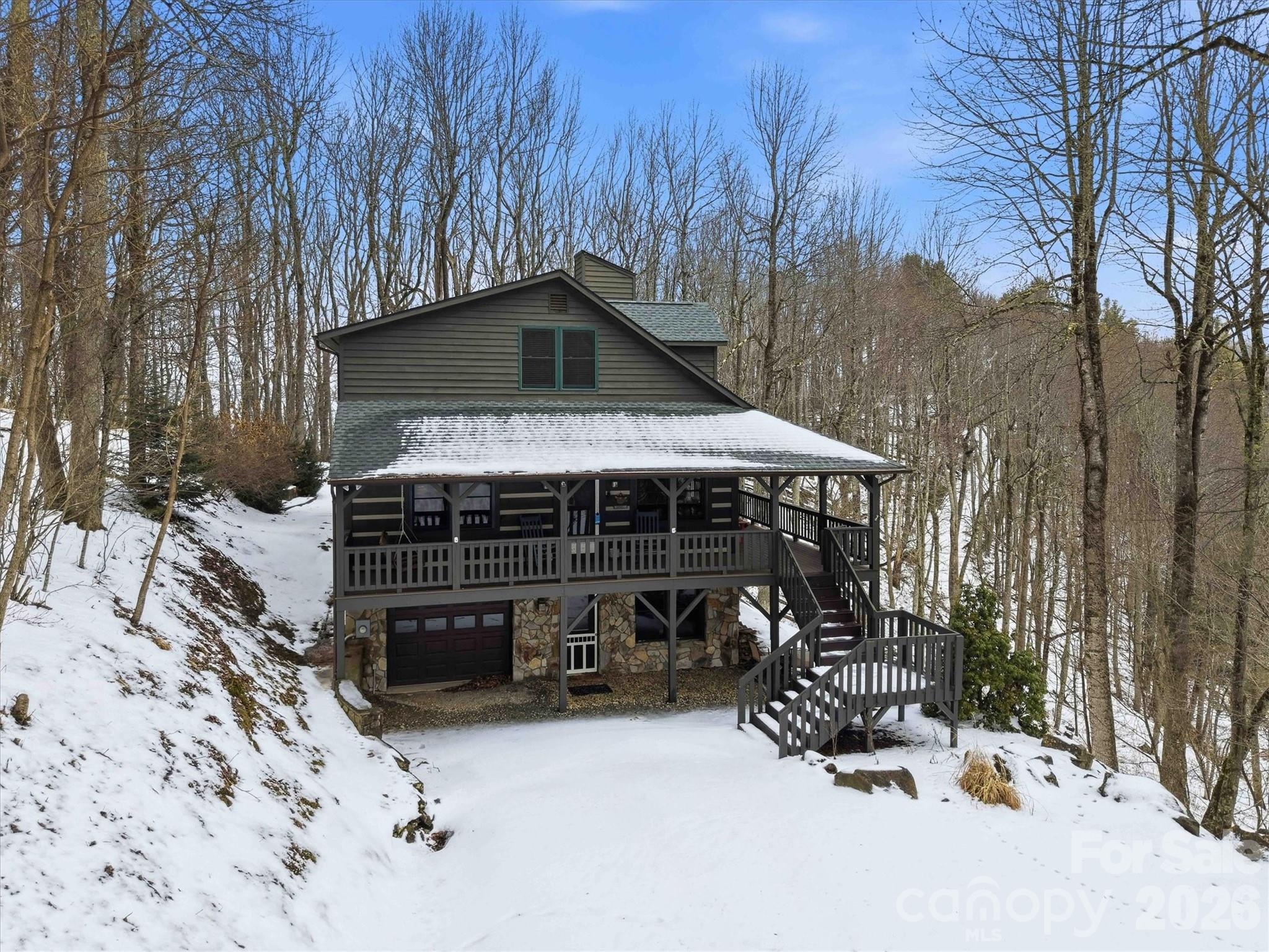 a view of a house with a yard covered in snow