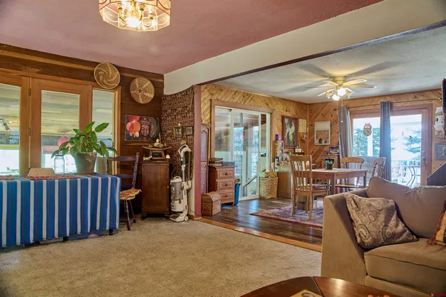 a living room with furniture a chandelier and a large window