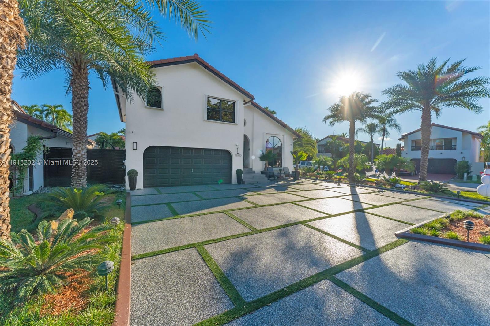 11830 Southwest 104th Lane Miami, FL 33186 - Photo 1 of 48 a front view of a house with a yard and garage