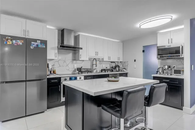 a kitchen with a sink a stove a refrigerator and a refrigerator