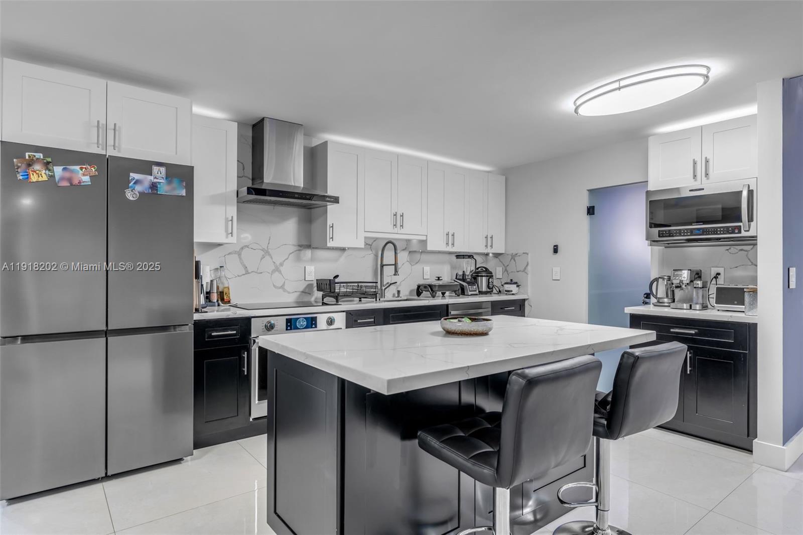 11830 Southwest 104th Lane Miami, FL 33186 - Photo 12 of 48 a kitchen with a sink a stove a refrigerator and a refrigerator