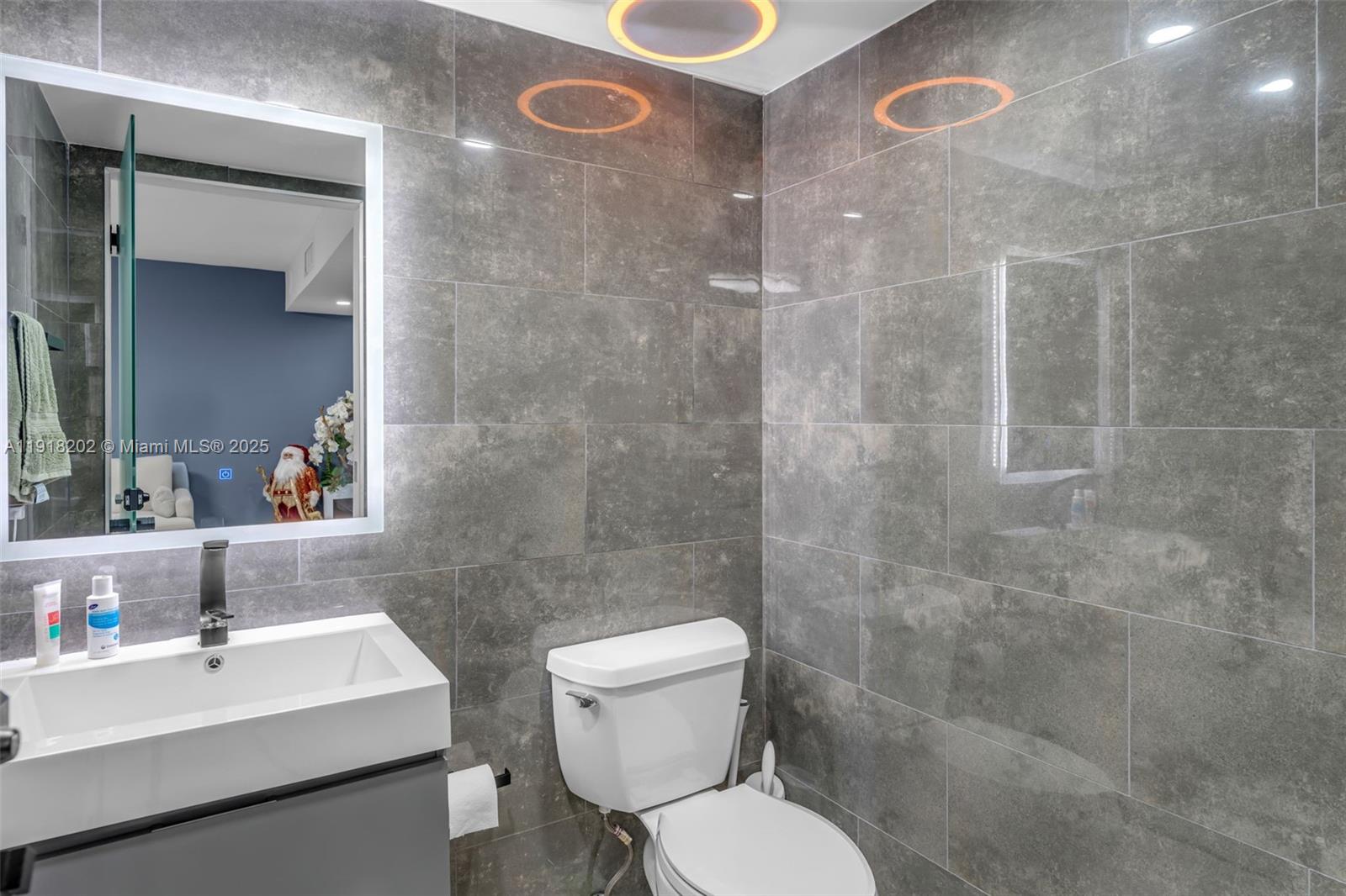 11830 Southwest 104th Lane Miami, FL 33186 - Photo 18 of 48 a bathroom with a sink toilet and shower