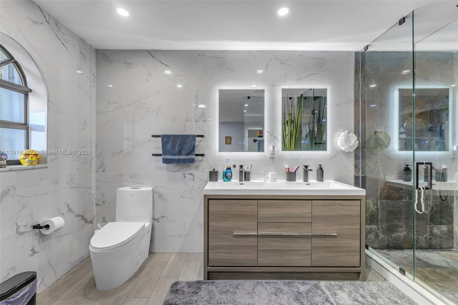 11830 Southwest 104th Lane Miami, FL 33186 - Photo 21 of 48 a bathroom with a toilet a sink and mirror