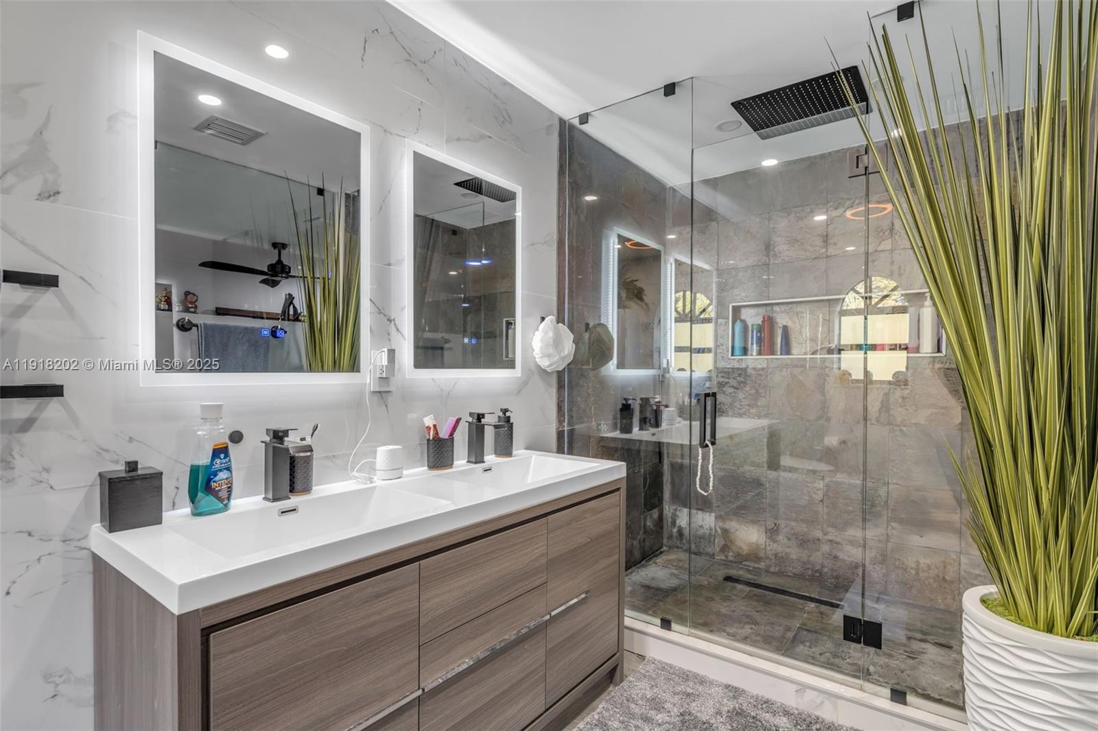 11830 Southwest 104th Lane Miami, FL 33186 - Photo 22 of 48 a bathroom with a shower sink and mirror