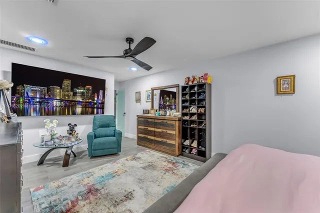 a bedroom with furniture and a book shelf