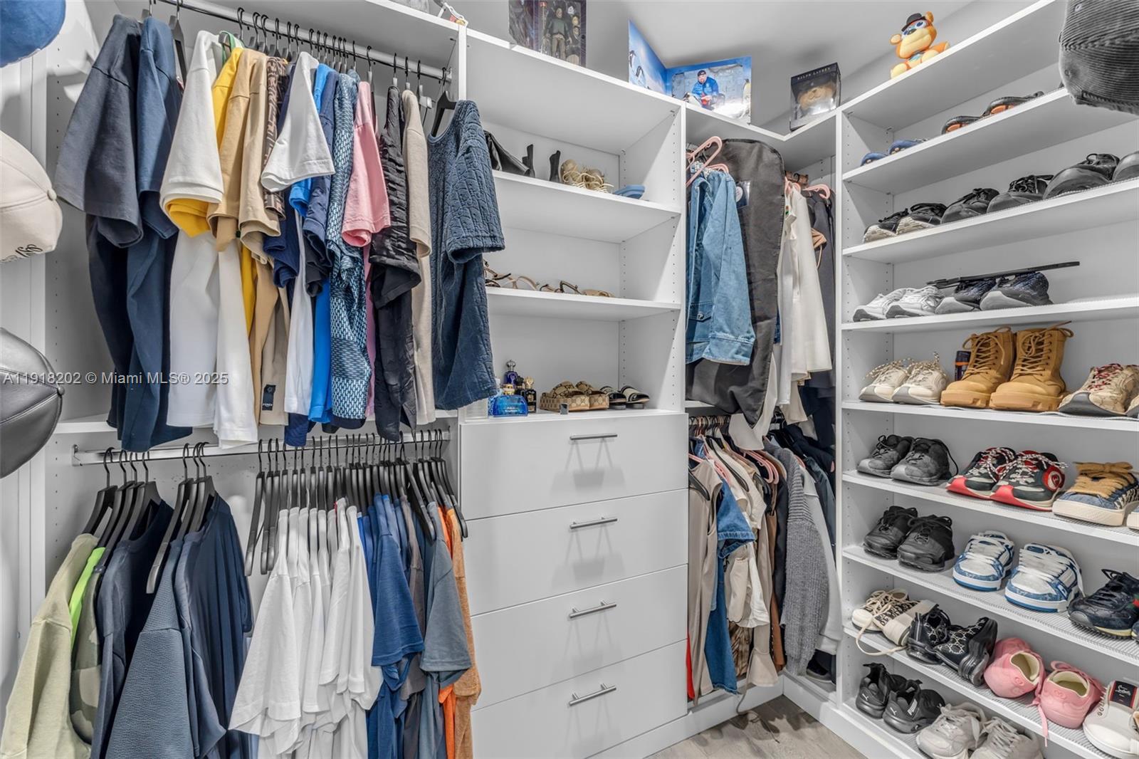 11830 Southwest 104th Lane Miami, FL 33186 - Photo 24 of 48 a view of walk in closet with clothes and shoes