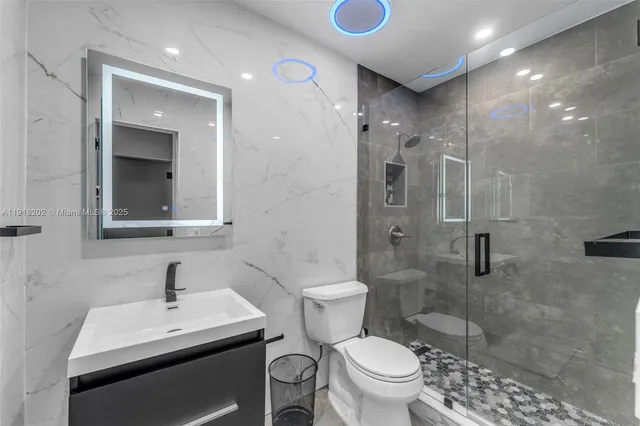 a bathroom with a sink toilet and shower